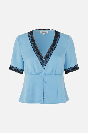 Front view of a light blue short-sleeved blouse with black lace trim, a deep V-neck and fabric-covered buttons.