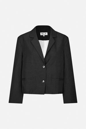 Front view of a cropped black blazer with notched lapels, two buttons, flap pockets and a white lining.