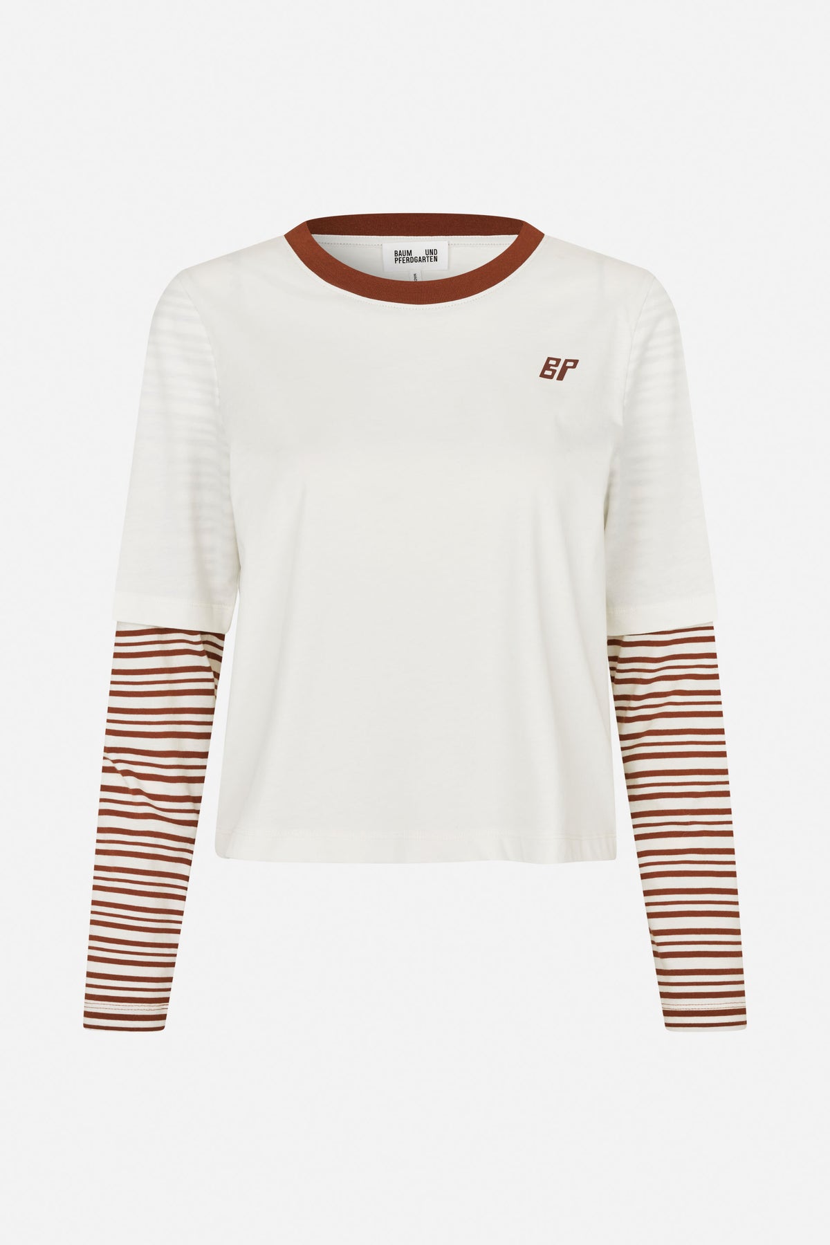 Front view of an ivory short-sleeve T-shirt layered over a rust-brown and ivory striped long-sleeve top, with a contrasting neckline and chest monogram.