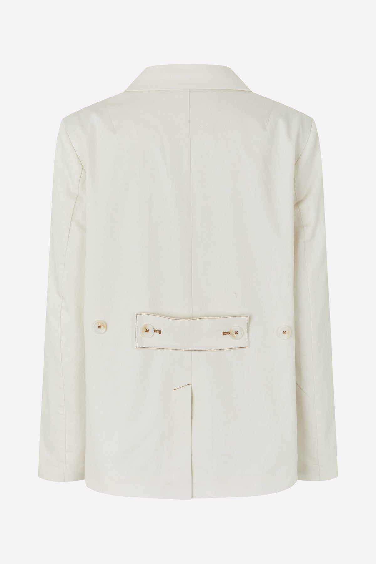 Back view of an ivory blazer with a center seam and buttoned waist tab outlined in brown stitching.