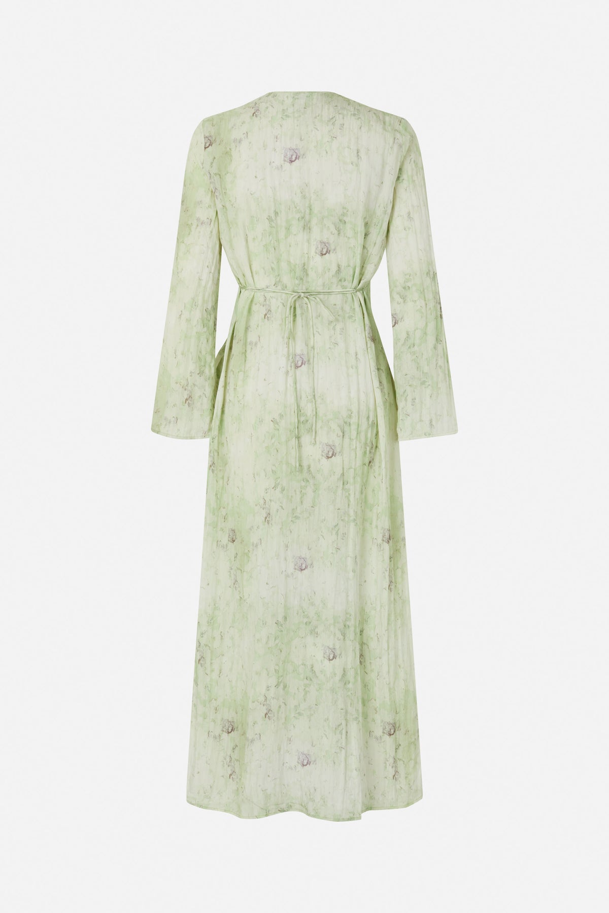 Back view of a long-sleeved pale green dress with a soft abstract floral print and a waist tie.