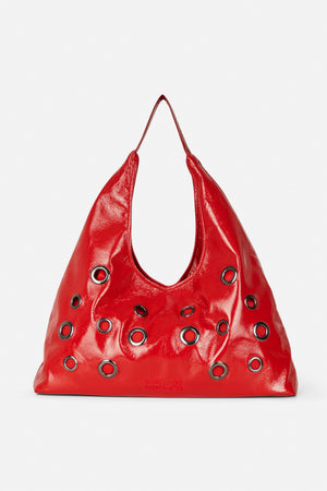 Glossy red shoulder bag with a single strap and multiple silver-tone grommets, shown from the front.