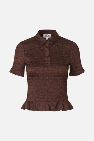 Front view of a dark brown short-sleeved blouse with a pointed collar, button placket, horizontal shirring and flounced hem.