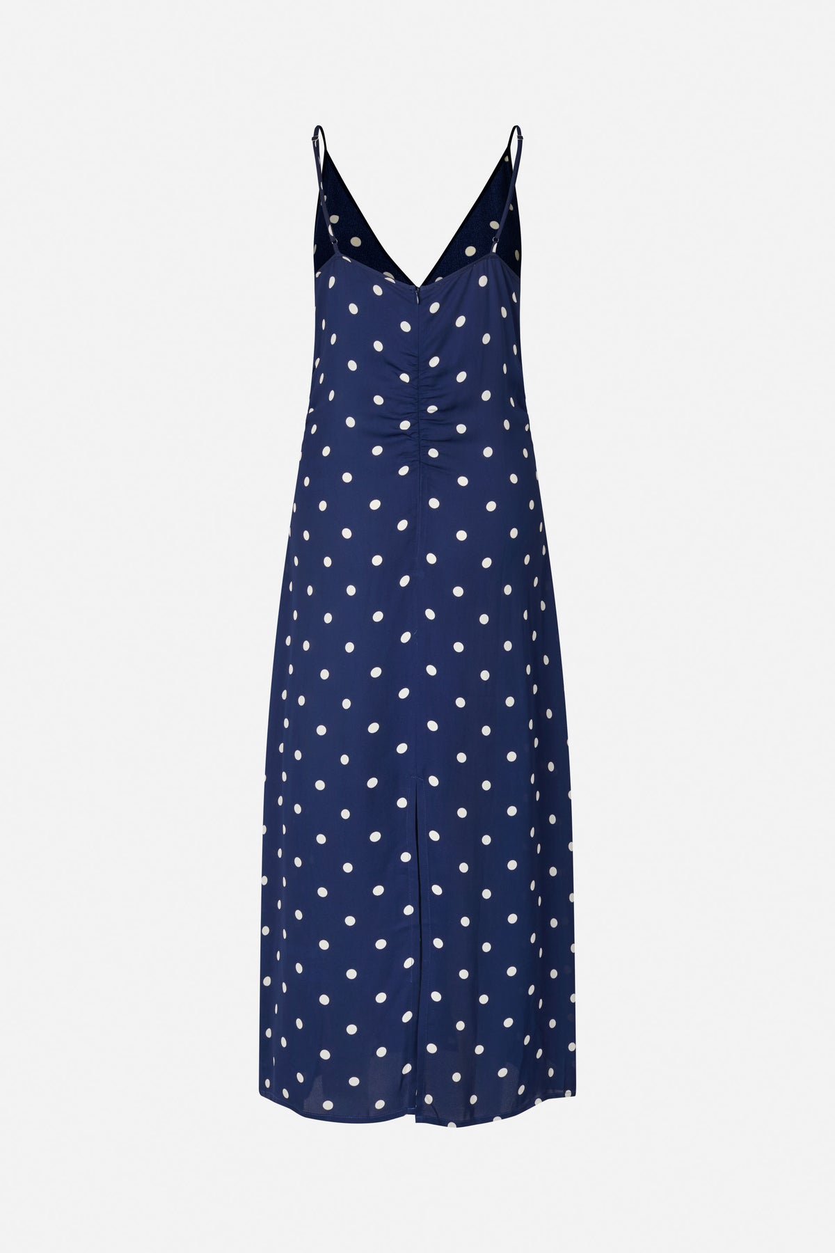 Front view of a navy spaghetti-strap slip dress with a deep V neckline and scattered white polka dots.