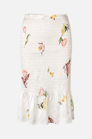 White skirt with a densely smocked waist and scattered pink, yellow and green floral print