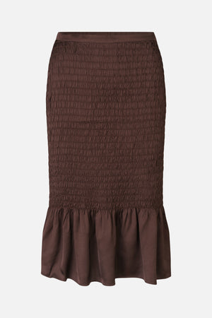 Dark brown skirt with a wide smocked body and gathered flared hem, shown from the front.
