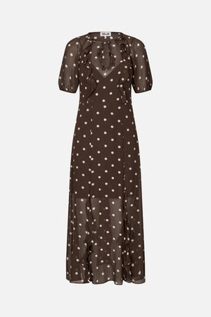 Front view of a sheer brown ankle-length dress with white polka dots, elbow-length sleeves and cascading ruffles down the front.