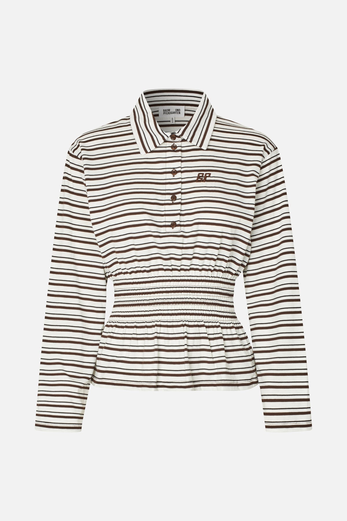 Front view of a cream long-sleeved collared shirt with brown horizontal stripes, a button placket, embroidered chest emblem and smocked waist.