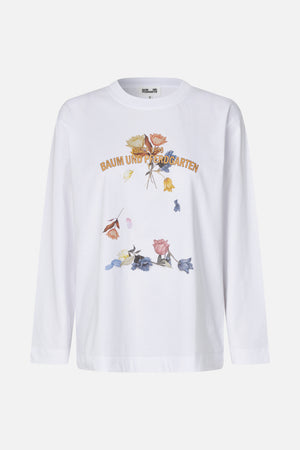 White long-sleeved crew-neck T-shirt with a colourful floral front graphic and “Since 1999” Baum und Pferdgarten lettering.