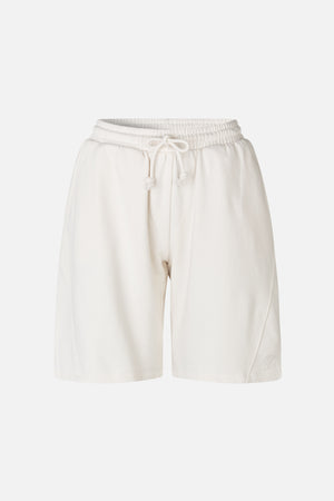 Front view of off-white sweat shorts with an elastic drawstring waist, wide legs and a small embroidered logo near the hem.