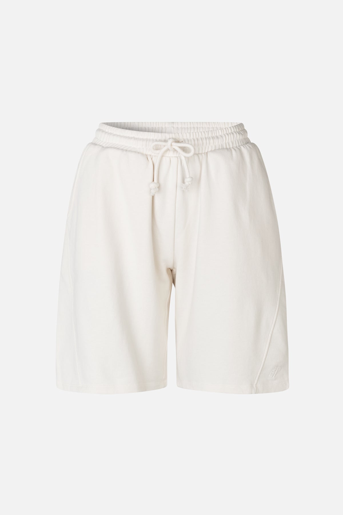 Front view of off-white sweat shorts with an elastic drawstring waist, wide legs and a small embroidered logo near the hem.