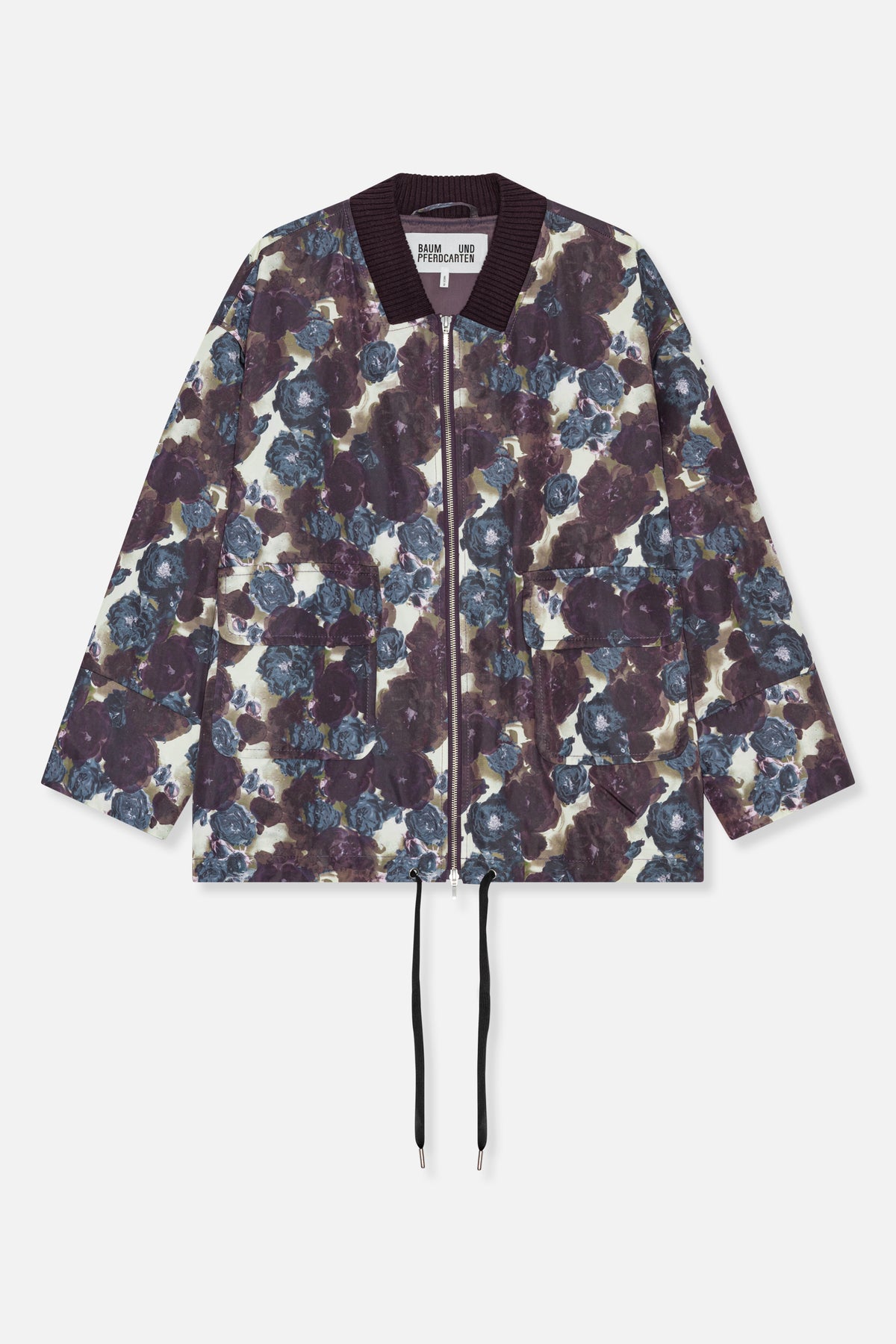 Front view of a floral-print zip jacket with a dark ribbed collar, large patch pockets and an adjustable drawstring hem.