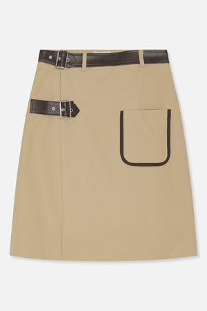 Front view of a beige A-line skirt with dark brown buckle straps at the waist and a large trimmed patch pocket.