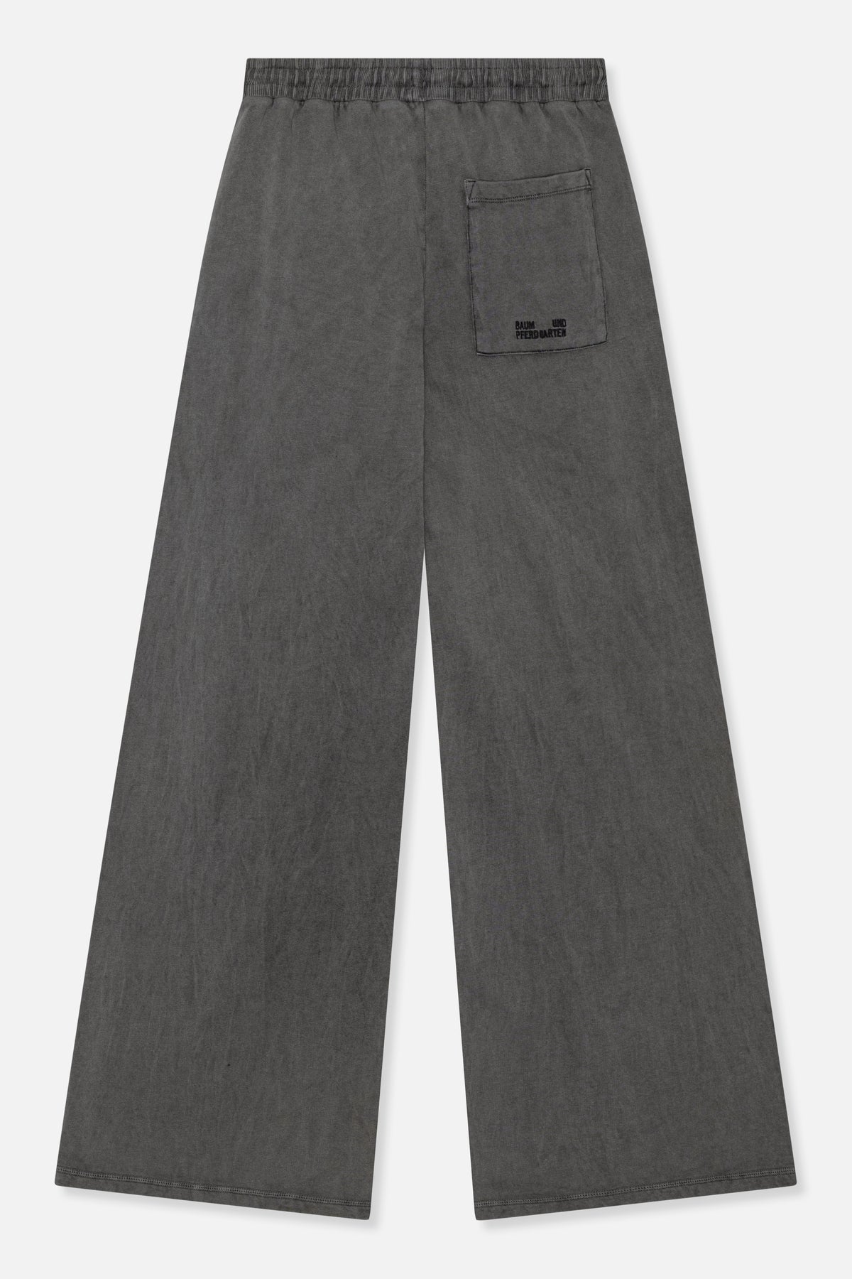 Back view of charcoal grey wide-leg trousers with an elasticated waistband and a patch pocket bearing a small logo.