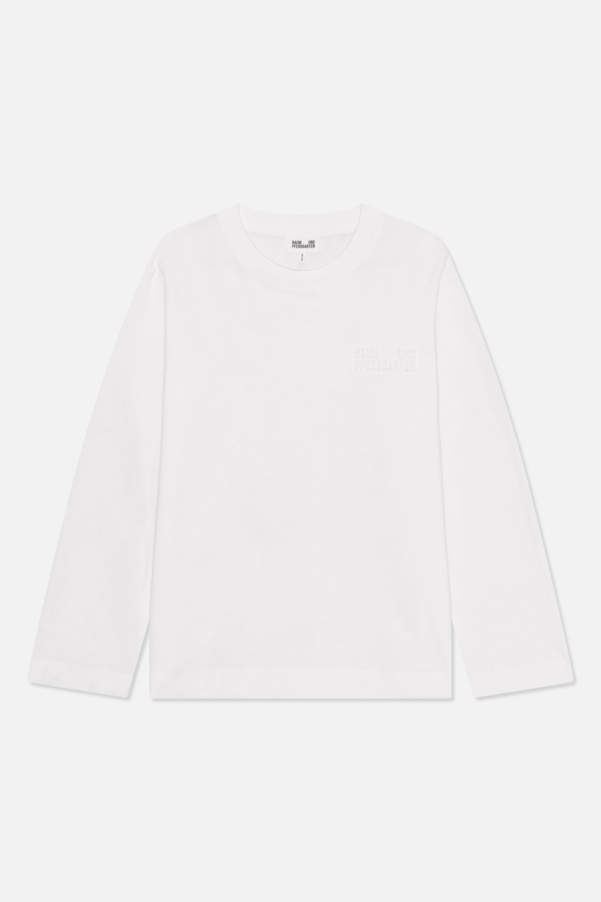 Front view of a white long-sleeved crew-neck shirt with subtle raised Baum und Pferdgarten lettering on the chest.