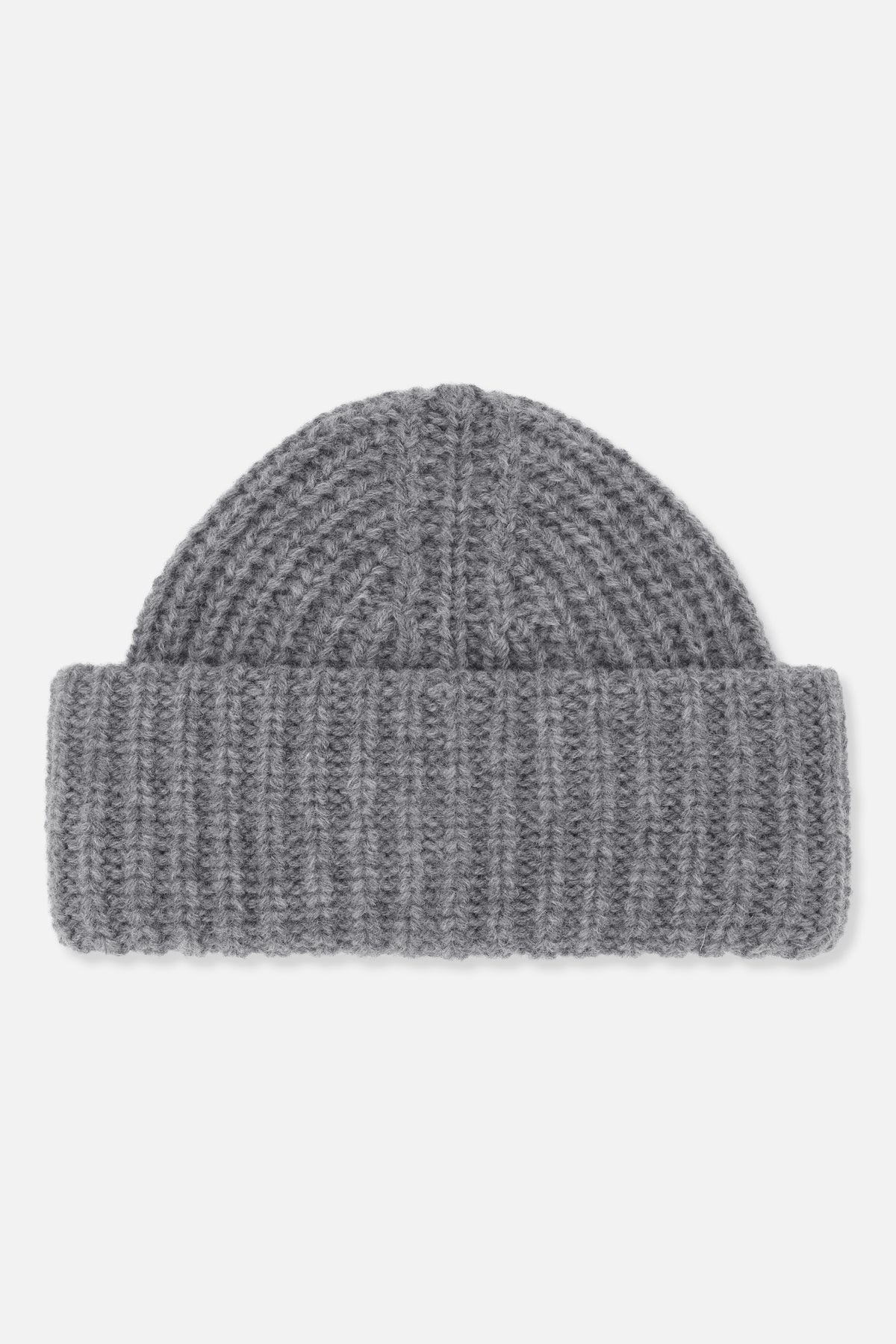 Close-up of a grey chunky-knit beanie with a wide folded cuff and textured stitch pattern