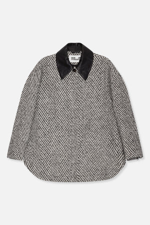 Front view of a black-and-white herringbone long-sleeved shirt with a large black collar and rounded hem