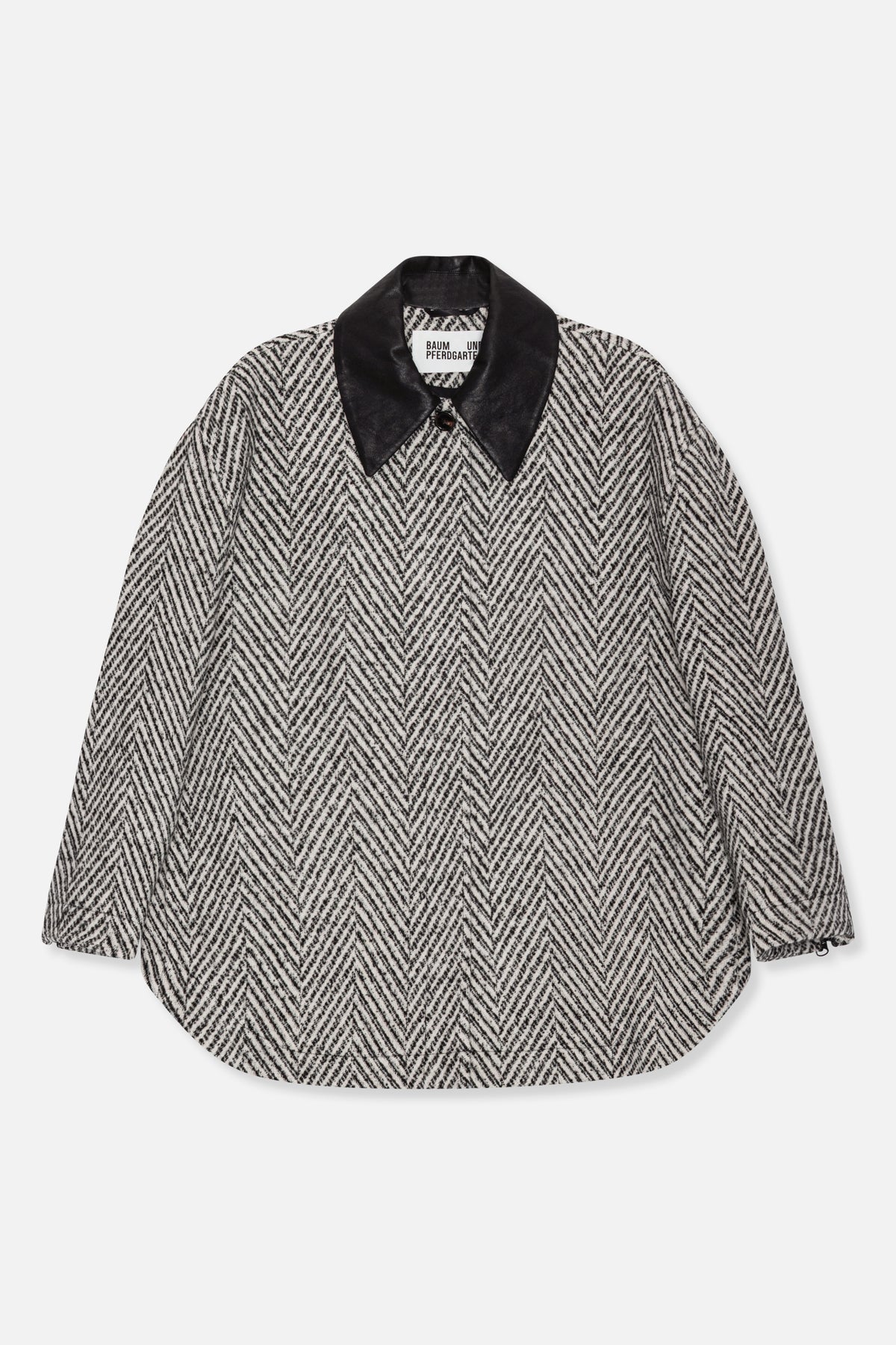 Front view of a black-and-white herringbone long-sleeved shirt with a large black collar and rounded hem