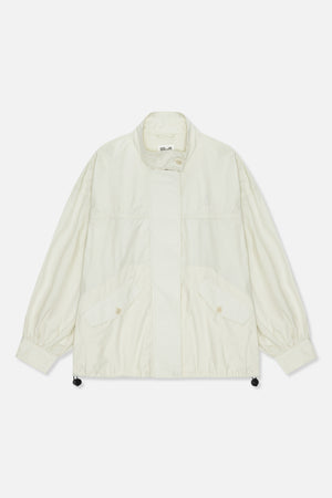 Front view of a light ivory jacket with a high collar, buttoned flap pockets, gathered cuffs and an embroidered chest logo.