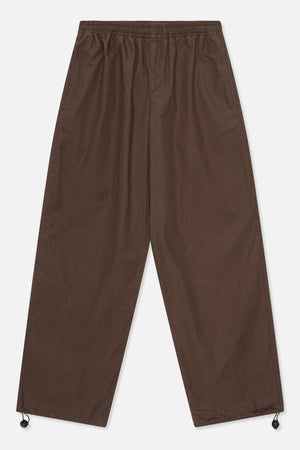 Front view of dark brown wide-leg trousers with an elasticated waistband and adjustable drawcords at the hems.