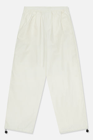 Front view of ivory wide-leg trousers with an elasticated waist, side pockets and adjustable drawcords at the hems.