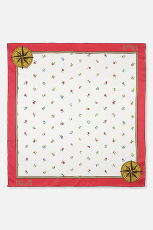 Square scarf with a white field of scattered multicoloured flowers, a red border, compass motifs and Baum und Pferdgarten lettering