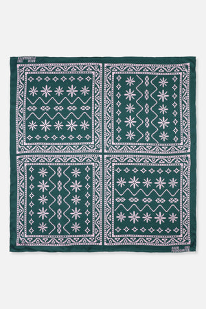 Square dark green scarf with pale pink geometric bandana panels and Baum und Pferdgarten lettering at the corners.