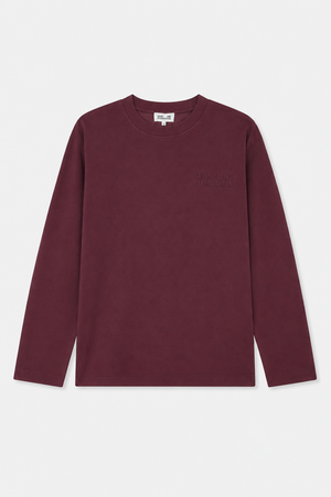 Front view of a burgundy long-sleeved crew-neck shirt with subtle tonal Baum und Pferdgarten lettering on the chest.