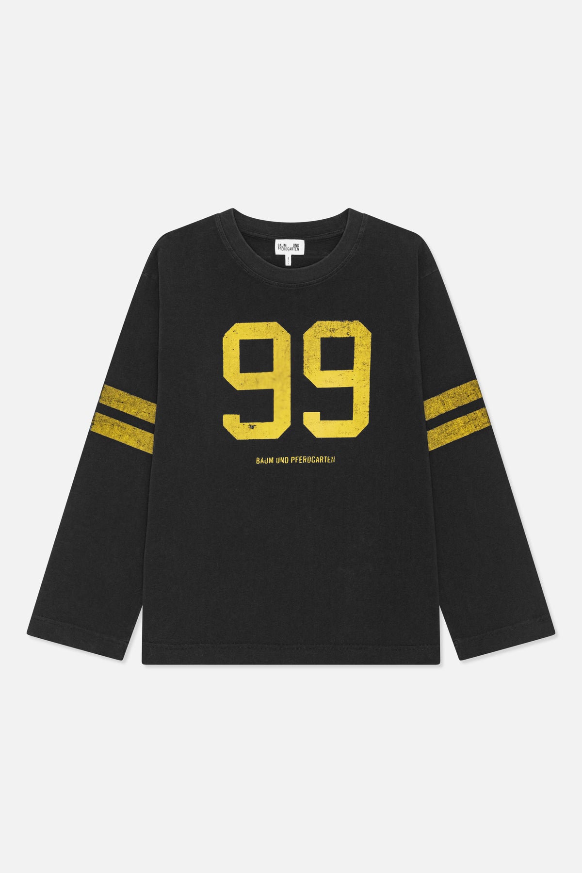 Front view of a black long-sleeved crew-neck top with distressed yellow “99” lettering and matching sleeve stripes.