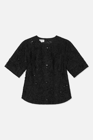 Back view of a black short-sleeved tunic with tone-on-tone floral texture, scattered sequins and a centre-back zipper.