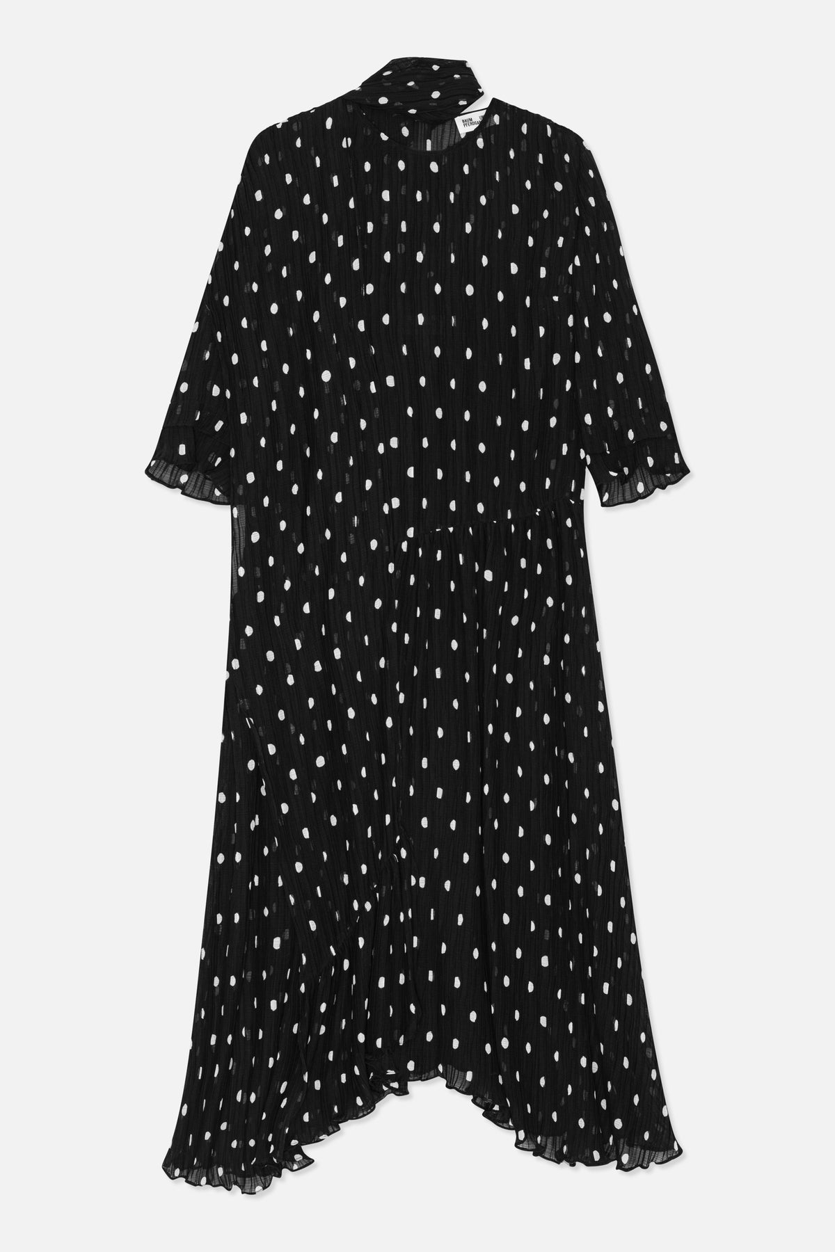 Front view of a black long dress with irregular white dots, a round neckline, three-quarter sleeves and a ruffled hem.