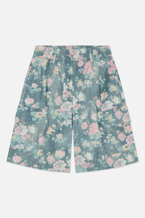 Front view of wide-leg denim shorts with a blue base, multicoloured floral print, elasticated waistband and large patch pockets.