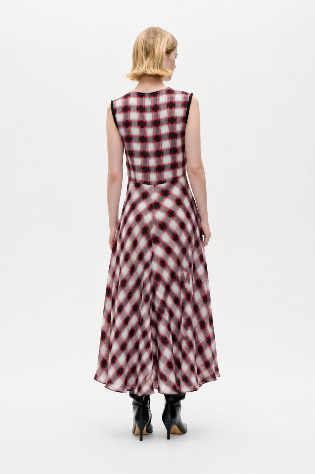 Back view of a sleeveless, ankle-length dress with a flared skirt in a red, black and white plaid pattern.