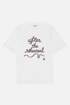 Front view of a white short-sleeve crew-neck T-shirt with pink script reading “after the rehearsal” and a ribbon graphic.